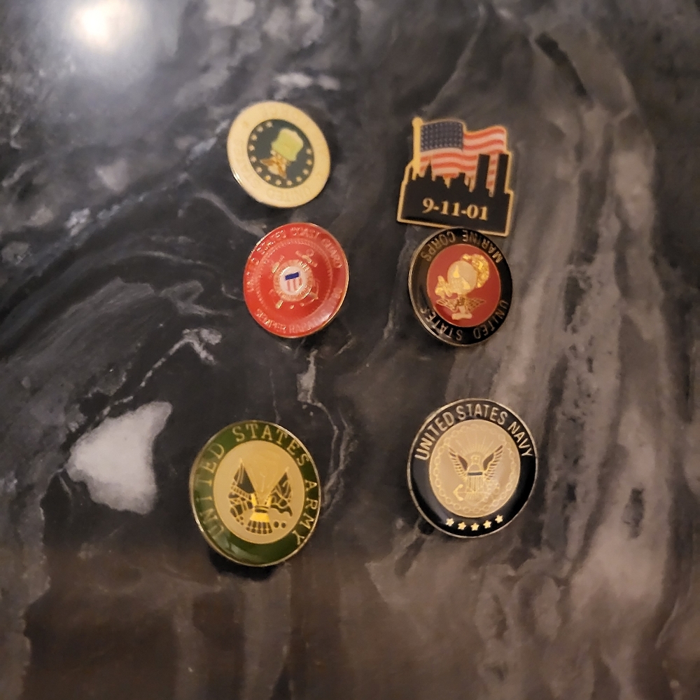 Six pins from different branches of the US military